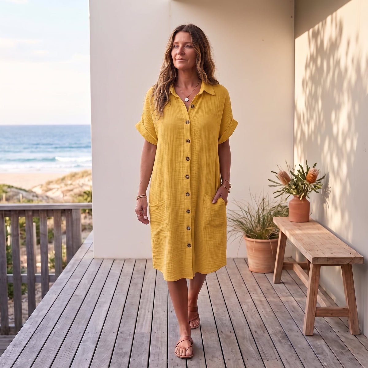 Gillian | Elegant Summer Dress – Yellow worn on an Australian coastal verandah