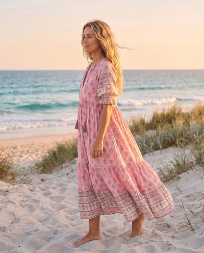 Side view of the Juno Floral V-Neck Maxi Dress in rose pink on an Australian beach at golden hour