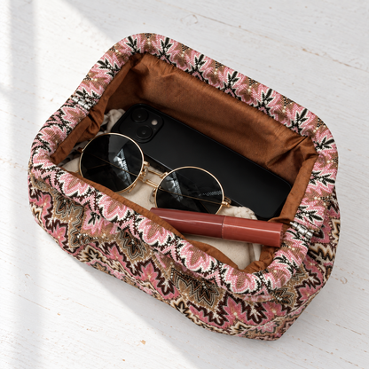 Juno Jacquard Pleated Clutch – open overhead view with phone, sunglasses, lip gloss and pouch on a white table